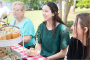 1 lb. Red Check Compostable Food Tray with sandwich during a family picnic 